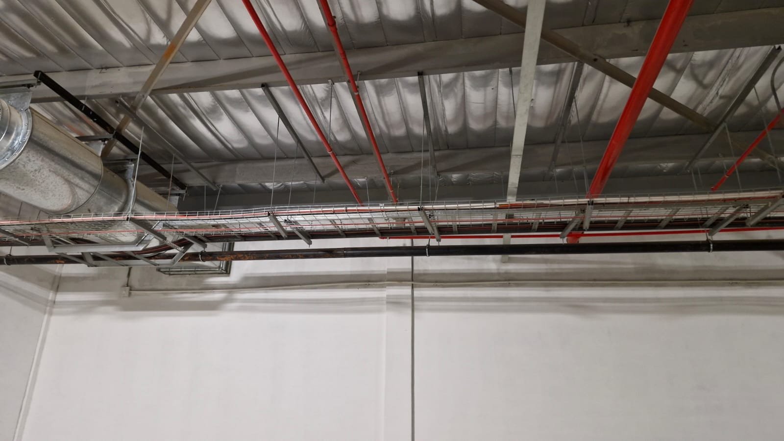 Electrical services routed above a ceiling